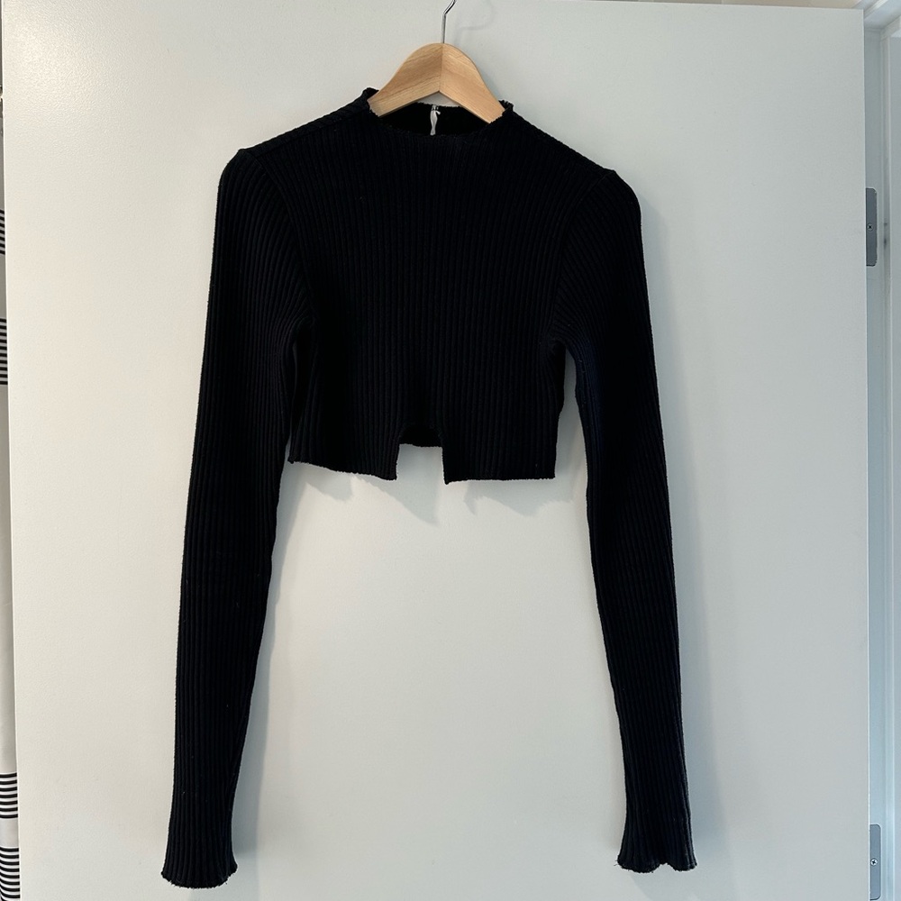 Areyouami long sleeve cutout ribbed sweater with high neck.